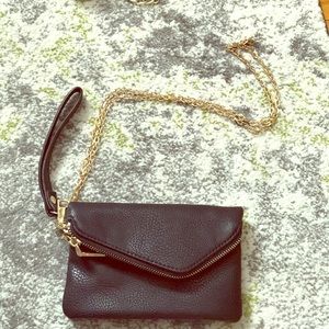 Small black clutch with gold link crossbody strap
